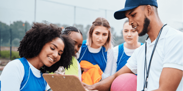 Coach teaching athletes